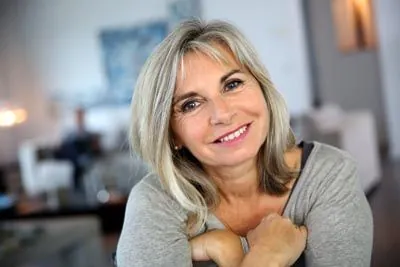 woman smiling big after getting dental implants at Little Mountain Dental