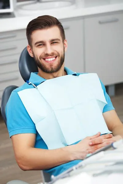 man smiling during his first visit to Little Mountain Dental